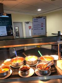 Canteen with food and ecolabels showing environmental impact of dishes